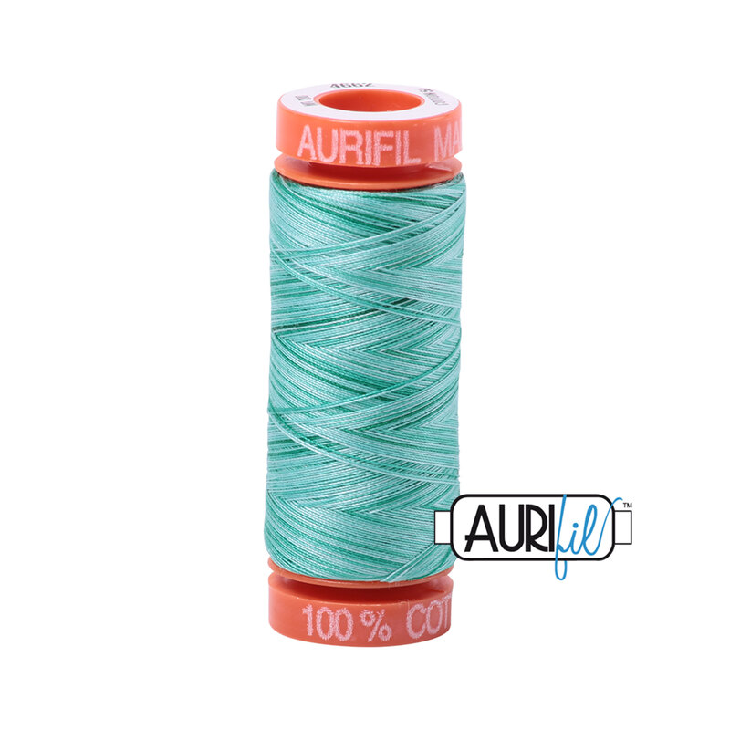 Creme de Menthe thread on an orange spool, isolated on a white background