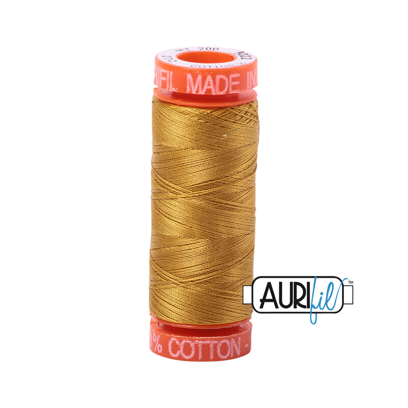 Mustard thread on an orange spool, isolated on a white background