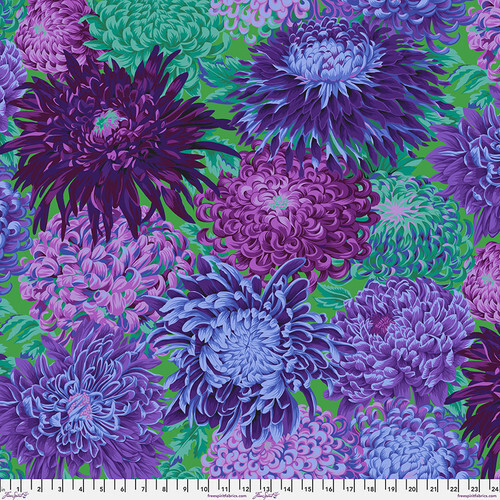 Fabric featuring vibrant green, blue, and purple chrysanthemums over a green background