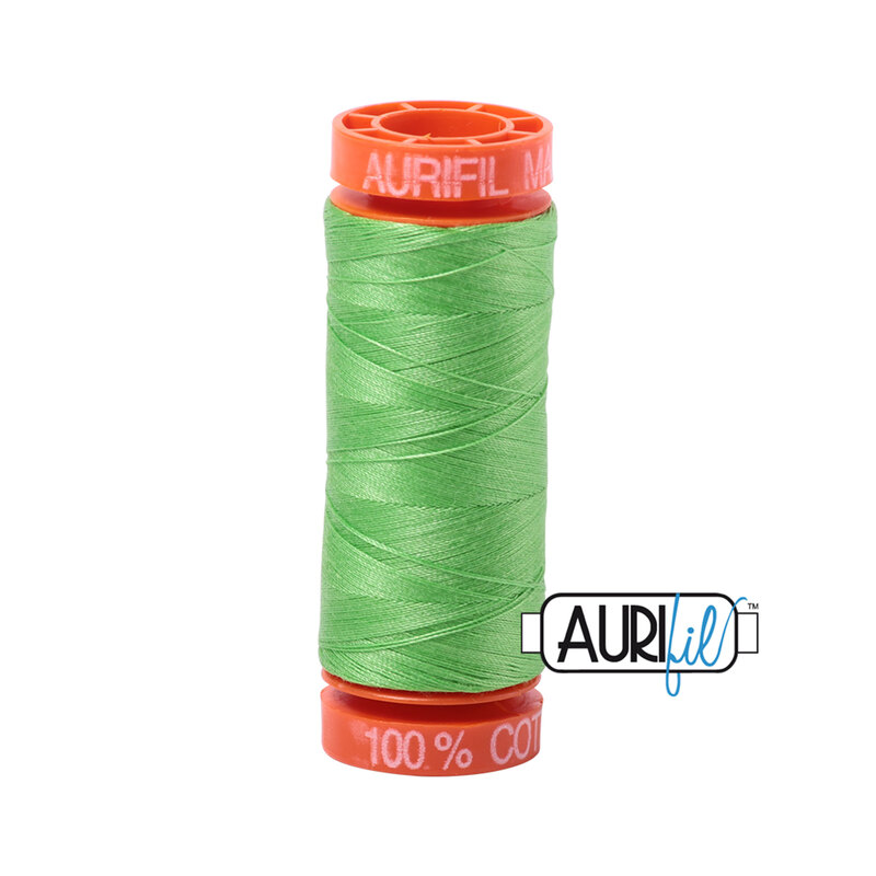 Shamrock Green thread on an orange spool, isolated on a white background