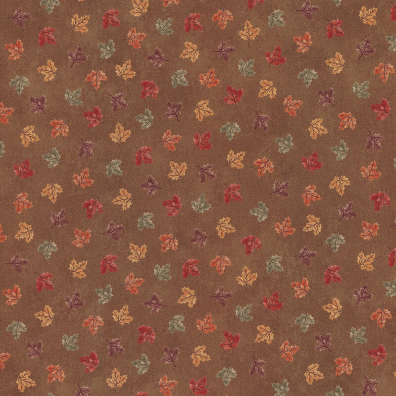 Brown fabric tossed with colored leaves 