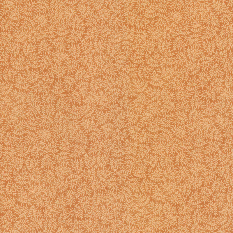 fabric featuring leaves on a orange background