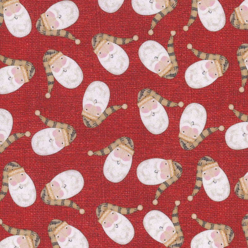 fabric featuring tossed Santa's on a red background