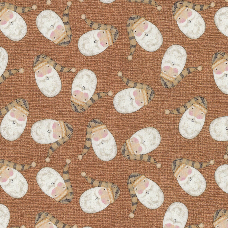 fabric featuring tossed Santa's on a brown background