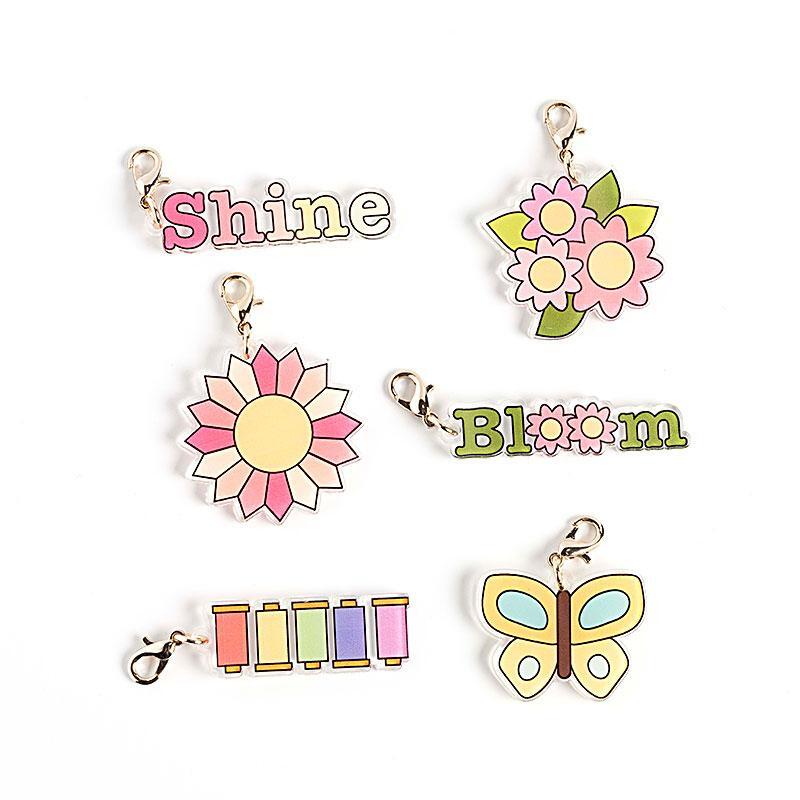 6 spring themed acrylic charms isolated on a white background