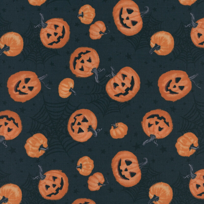 fabric featuring pumpkins and jack o'lanterns on a dark grey background with spiderwebs and stars