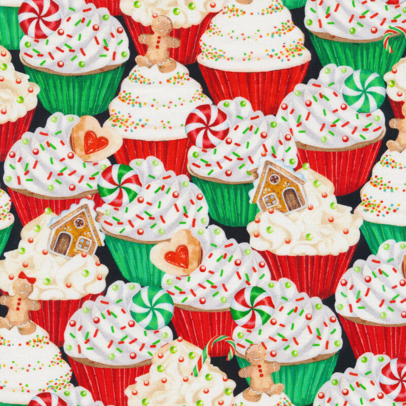 Black fabric with a pattern of cupcakes with holiday treat toppings.