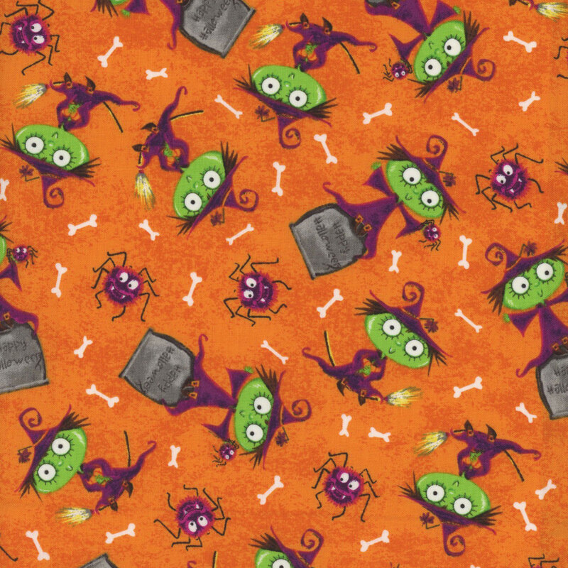 textured orange fabric, featuring scattered witches and gravestones, with bones and spiders sprinkled in between