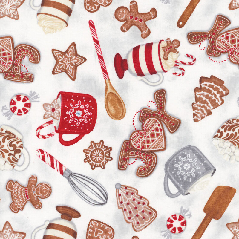white fabric tossed with cookies, hot cocoa and baking utensils