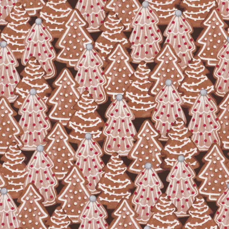 fabric featuring decorated Christmas tree cookies on a brown background