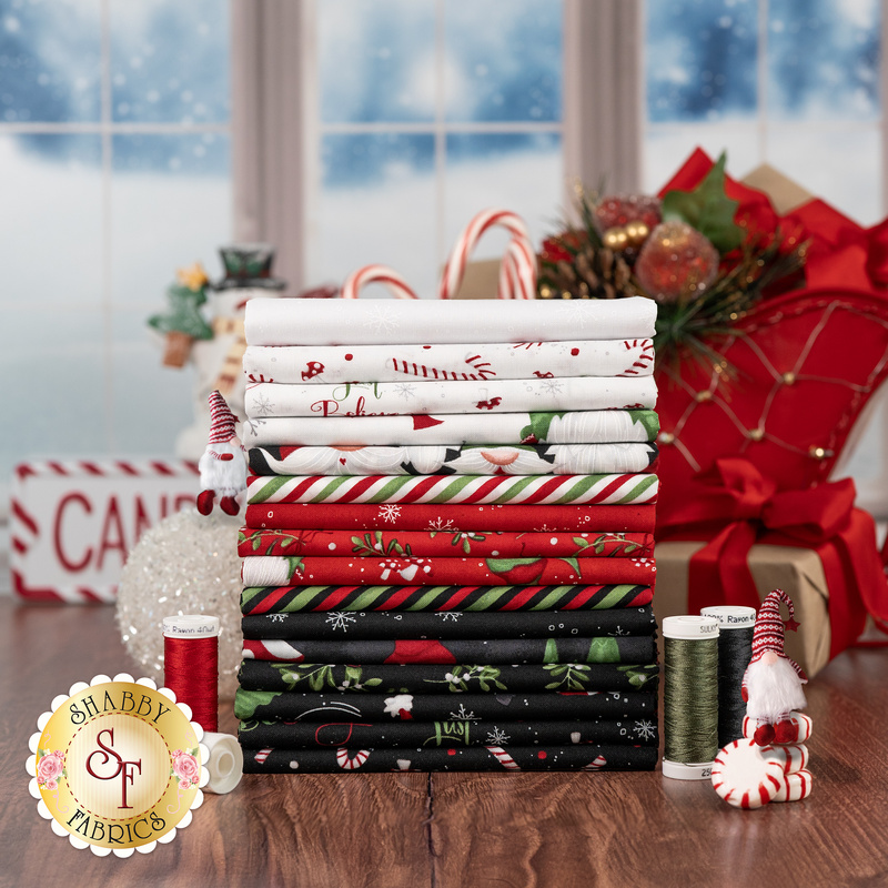 Styled photography of red, black, and white fabrics featuring gnomes and Christmas things included in the Our Gnome to Yours collection.