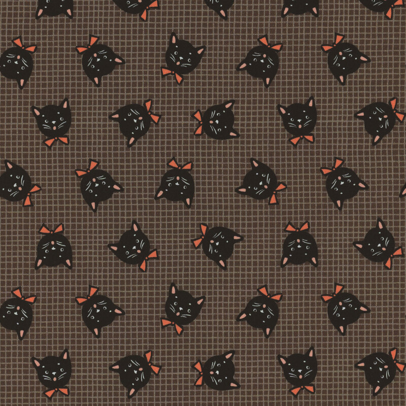 Dark gray fabric with thin tonal grid lines in the background and tossed black cat heads wearing orange bow ties