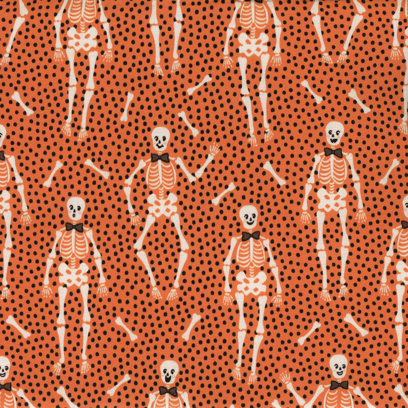 Orange fabric with tiny black dots close together and upright bow tie wearing skeletons with long bones tossed between them