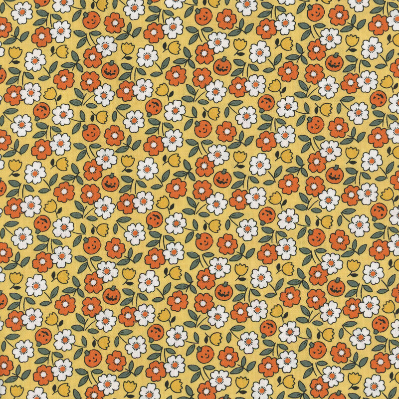 Yellow fabric featuring tossed white, orange, and yellow flowers amid small jack-o-lanterns.