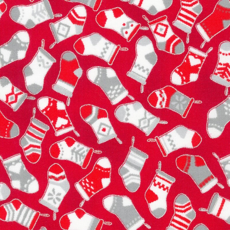 red fabric tossed with christmas stockings