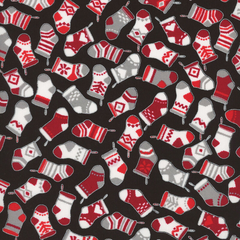 Black fabric tossed with christmas stockings