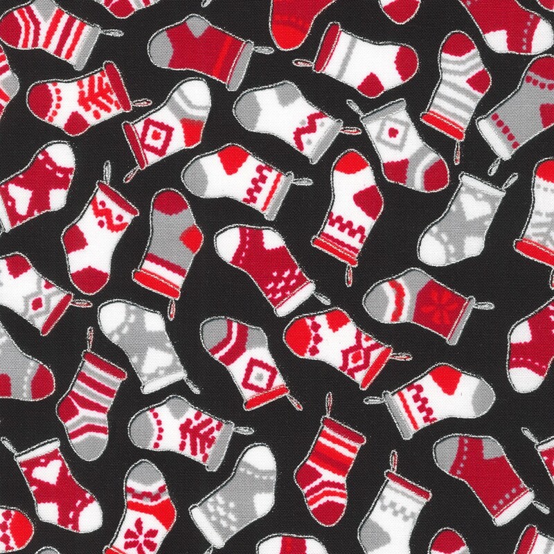 Black fabric tossed with christmas stockings