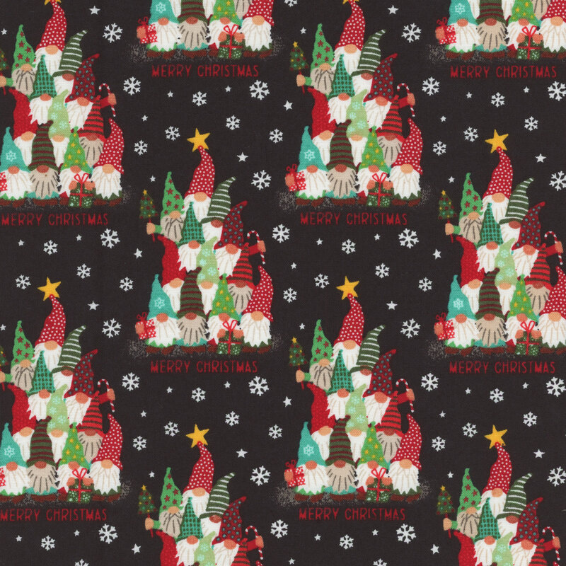 Black fabric with small white snowflakes and gnomes stacked on top of each other in Christmas tree formation.