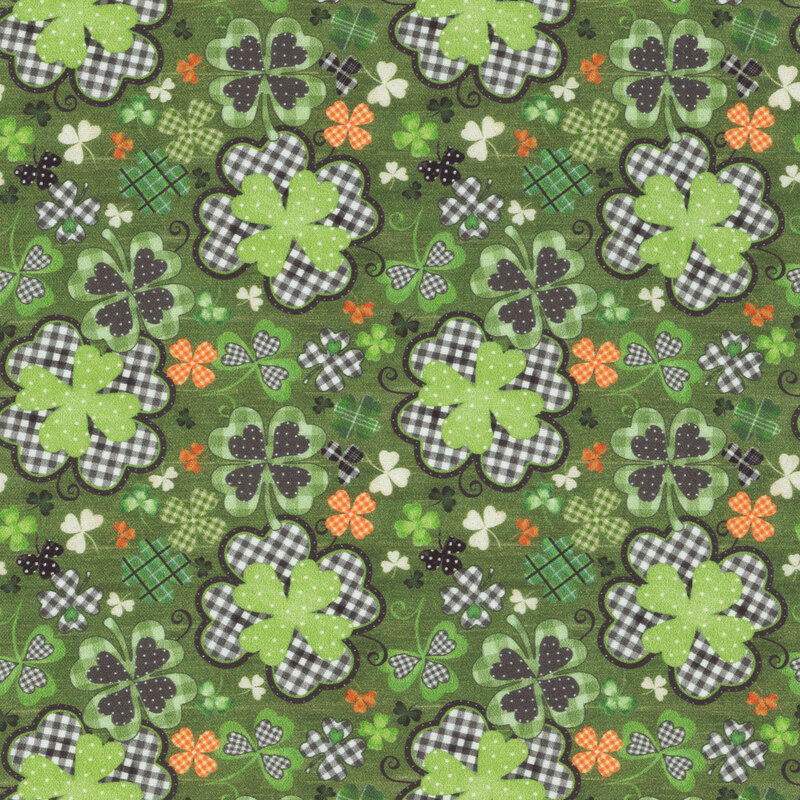 fabric featuring shamrocks with plaid and polka dotted designs on a green textured background