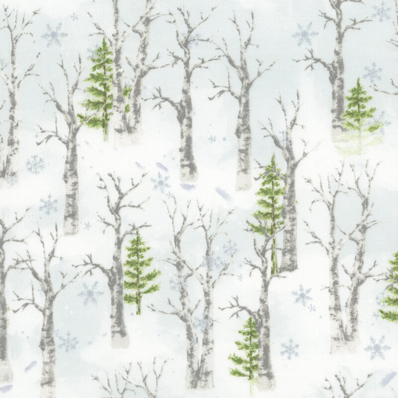 Fabric featuring trees, snow and falling snowflakes in the winter