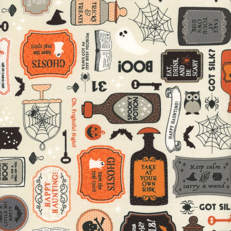 cream fabric featuring spooky potions, signs, webs, and other halloween themed elements