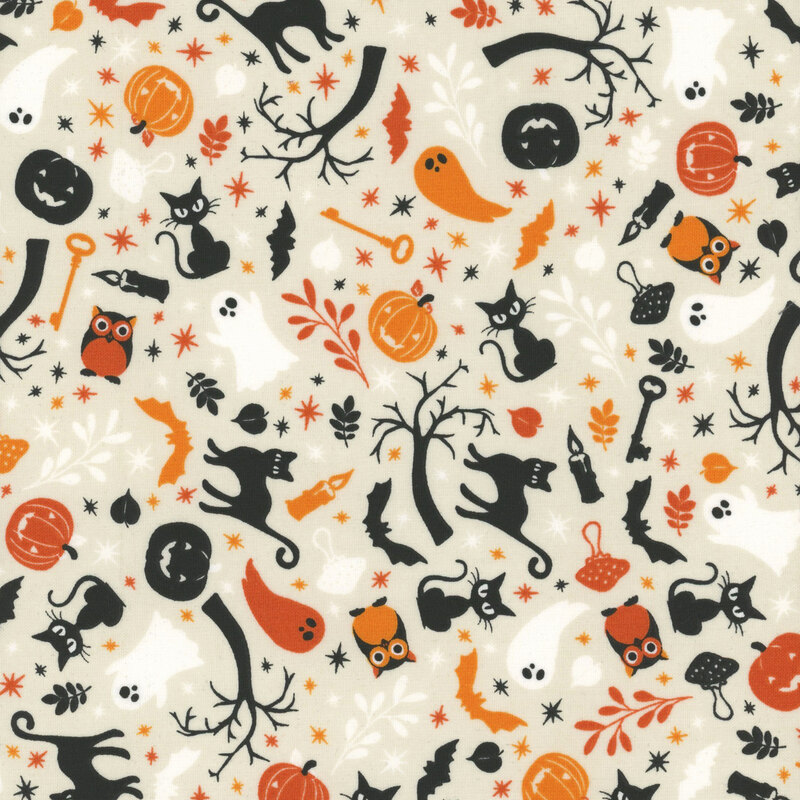 cream fabric featuring cats, jack o'lanterns, ghosts and other halloween themed motifs