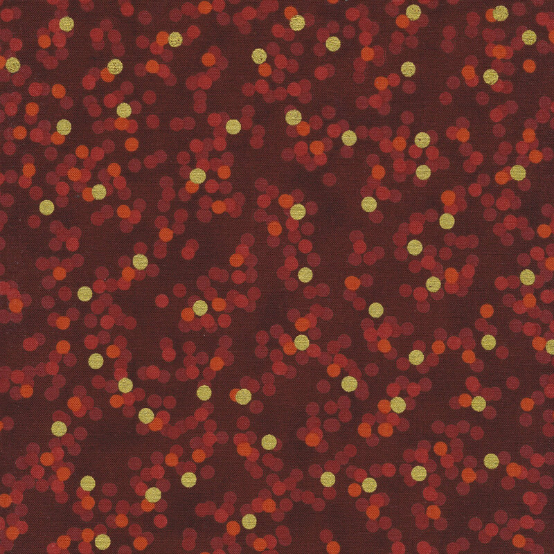 dark red fabric featuring orange and red dots with gold metallic dots