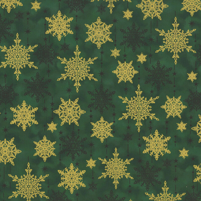 gorgeous green mottled fabric with scattered tonal and metallic gold snowflakes with tonal dots, stars, and dashes mimicking the falling of snow