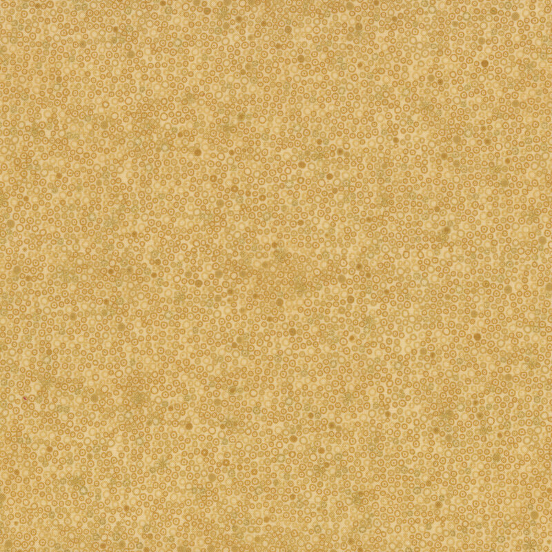 lovely warm tan fabric with a packed together design of tonal and metallic gold circles