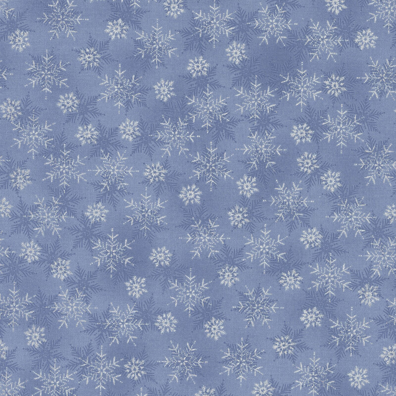 beautiful denim blue fabric with scattered tonal and metallic silver snowflakes