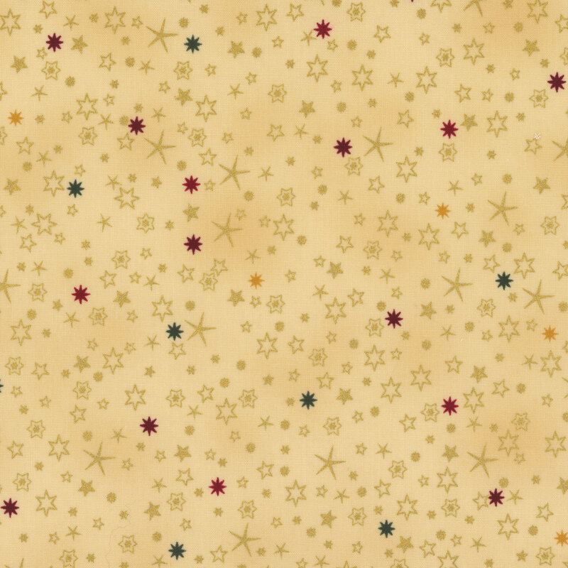 lovely warm tan fabric with scattered metallic gold, dark green, dark red, and golden yellow stars