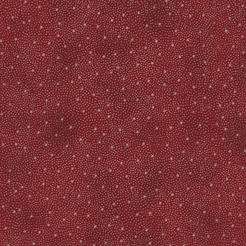 gorgeous red fabric with tiny scattered metallic silver stars surrounded by pin dots in a radiating pattern