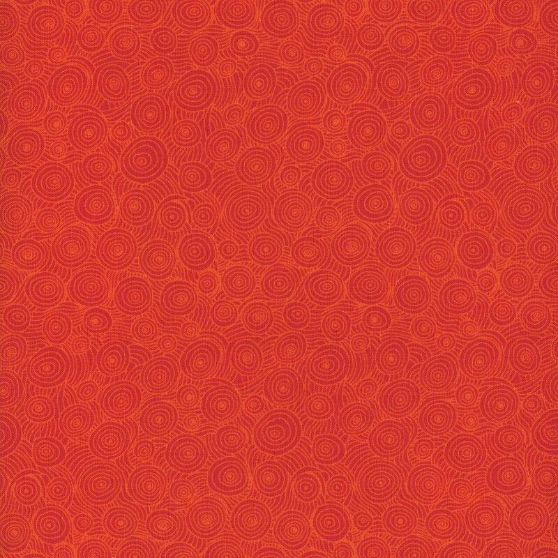 Scan of red orange fabric with a swirling pattern