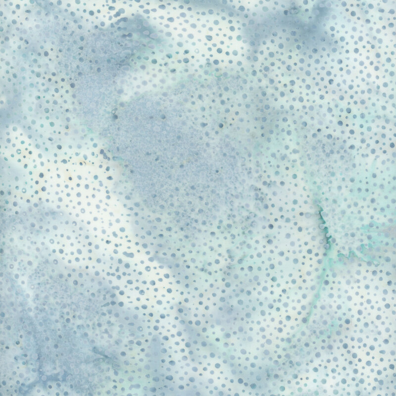 pale bluish grey batik fabric with small tonal dots scattered across it