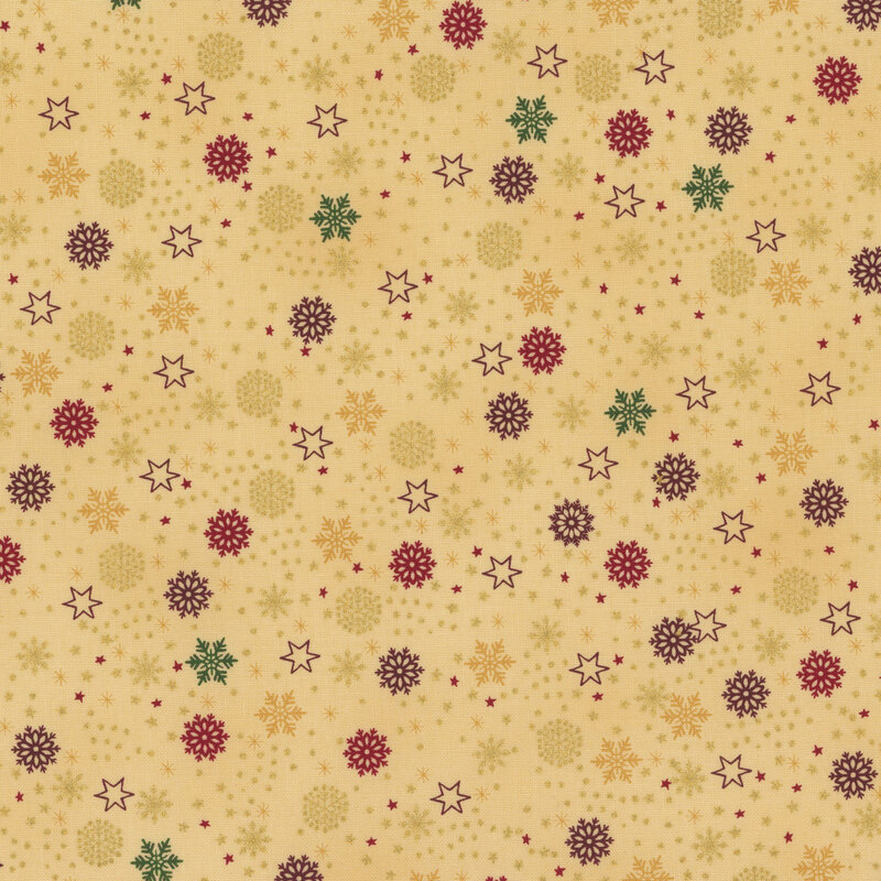 beautiful warm tan fabric with scattered metallic gold, green, dark red, and golden yellow snowflakes, stars, and dots