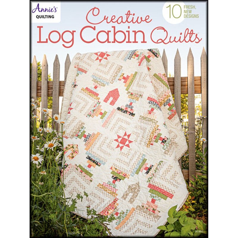 Front of pattern book showing a beautiful quilt staged over a fence in a backyard