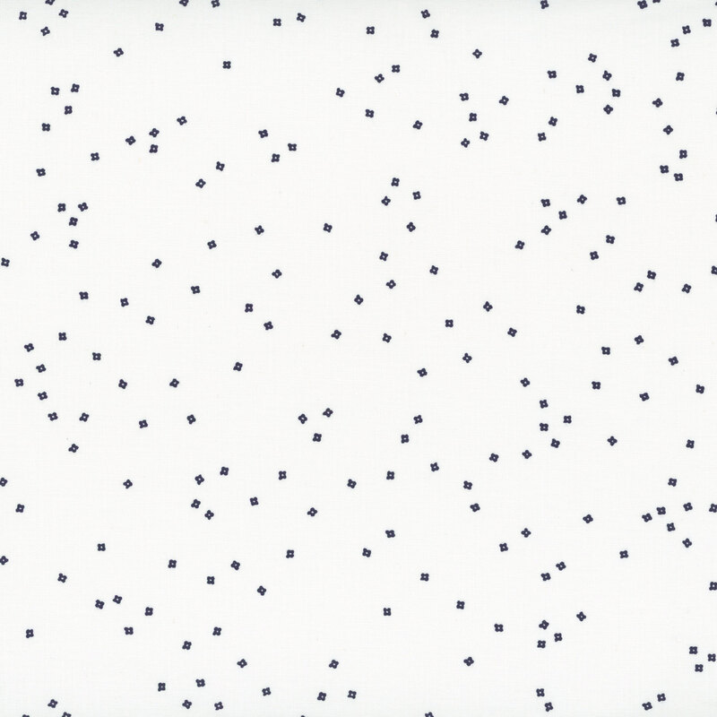 Small navy blue blossoms scattered on a white background fabric