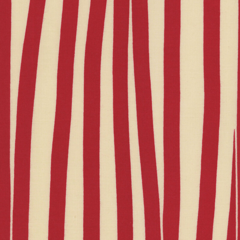 dark cream fabric featuring uneven and overlapping stripes of red ribbon