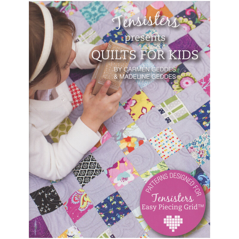 Front of the pattern book showing a little girl atop a lilac and patchwork quilt