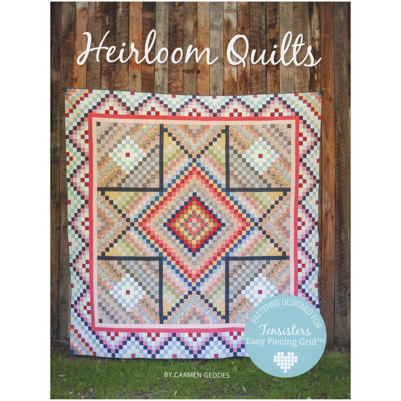 Front of pattern book, a large pieced prairie star quilt staged in front of rustic wood paneling