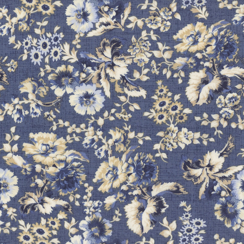denim blue textured fabric featuring scattered textured florals in shades of cream, white, and blue