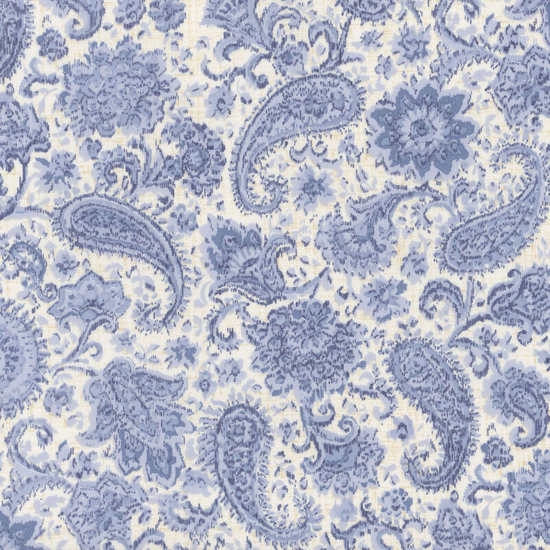 off white textured fabric featuring scattered textured florals and paisley motifs in shades of blue