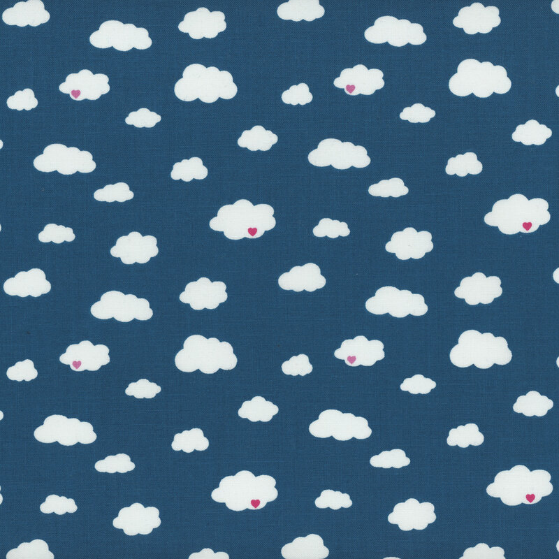 Image of a medium blue fabric with tossed white clouds. Some clouds have little pink hearts on them!