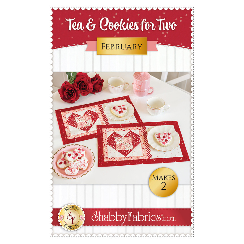 Front cover of the Tea & Cookies for Two - February pattern, featuring a white table staged with two placemats, red roses, plates of cookies, two white teacups, and a pink pearlescent teapot.