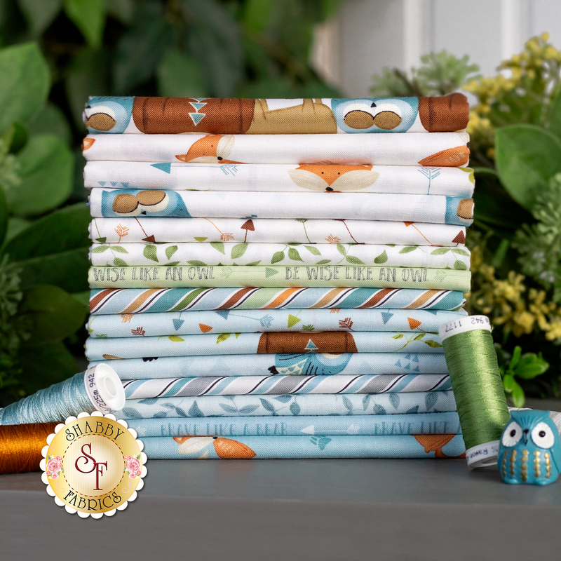A stack of all the fabrics included in the Winsome Critters FQ set.