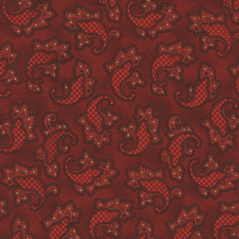 Red fabric with embellished paisley motifs with gingham details.