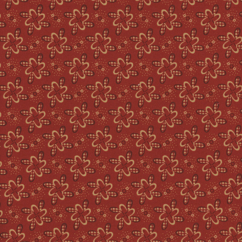Red fabric with pinwheel-like floral motifs with red gingham details.