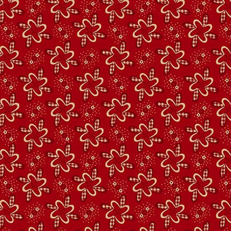 Red fabric with pinwheel-like floral motifs with red gingham details.