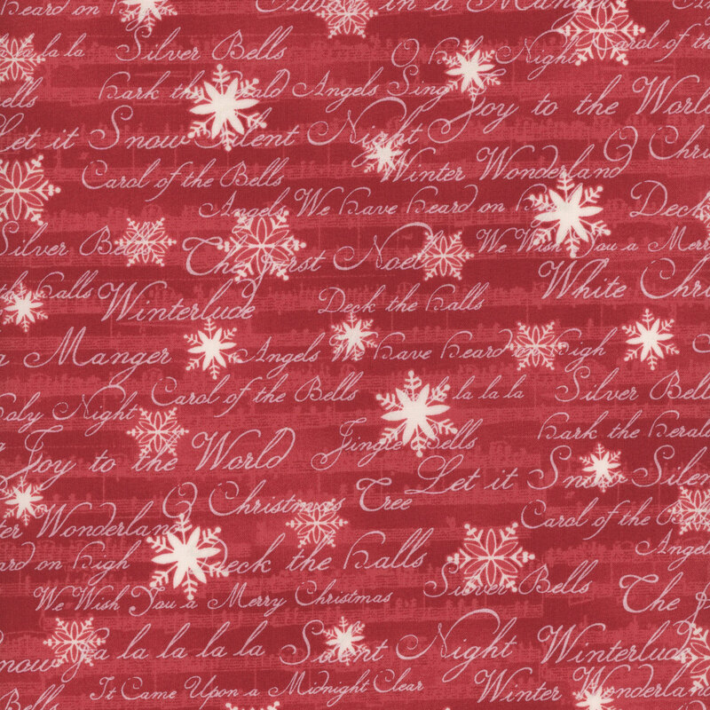 This fabric features white snowflakes and words in script on a red background expressing lyrics and titles of beloved Christmas carols