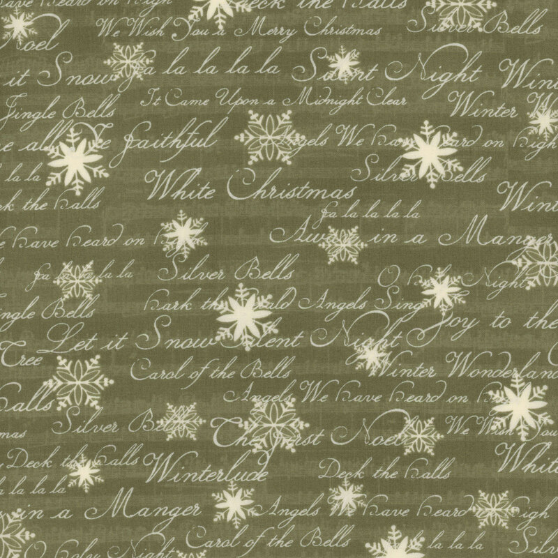 This fabric features white snowflakes and words in script on a green background expressing lyrics and titles of beloved Christmas carols